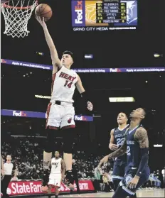  ?? BRANDON DILL/AP ?? MIAMI HEAT GUARD TYLER HERRO (14) shoots during the first half of the team’s game against the Memphis Grizzlies on Saturday in Memphis, Tenn.