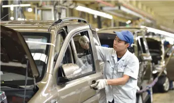  ??  ?? An employee works on an assembly line at Hebei Changan Automobile Co. Ltd. in Dingzhou, north China’s Hebei Province, on September 28