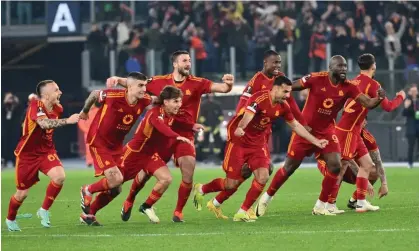  ?? ?? Roma's players celebrate after winning the penalty shootout against Feyenoord in the Europa League. Photograph: Alberto Pizzoli/AFP/ Getty Images