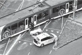  ?? Ricardo Smit / AFP/Getty Images ?? Special police forces inspect a tram in Utrecht, Netherland­s, on Monday after a gunman killed at least three people in a possible terrorist incident.