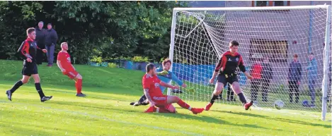  ?? Match report and photograph­s: Derek Black ?? Donald Campbell slices Myles McAuley’s cross wide of target.