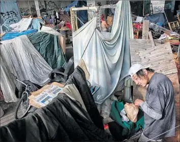  ?? Robert Gauthier Los Angeles Times ?? FRANK RODRIGUEZ, 63, spends Sunday under the 4th Street Bridge in Los Angeles. In anticipati­on of the storm, the Midnight Mission on skid row plans to open its dining hall to shelter an extra 100 people.