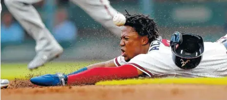  ?? AP PHOTO/JOHN BAZEMORE ?? The Atlanta Braves’ Ronald Acuna Jr. slides ahead of the throw from Washington Nationals catcher Kurt Suzuki as Acuna steals second base during the first inning of the game Thursday in Atlanta. He scored to put the Braves ahead, but the lead did not last.