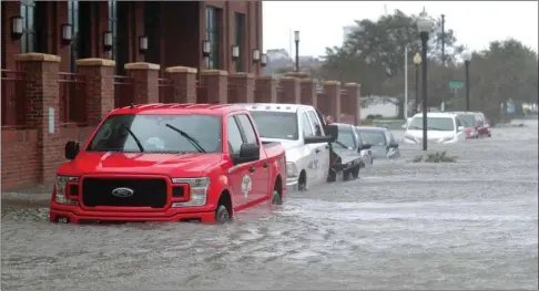  ??  ?? Vehicles are seen in a flooded street as Hurricane Sally passes through Pensacola, Florida, yesterday.