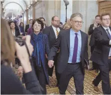  ?? AP PHOTO ?? POL PROBLEMS: U.S. Sen. Al Franken holds hands with his wife, Franni Bryson, at the Capitol yesterday.