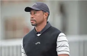  ?? AARON DOSTER/USA TODAY SPORTS ?? Tiger Woods walks off the Valhalla course Tuesday as play was suspended due to inclement weather during a practice round.