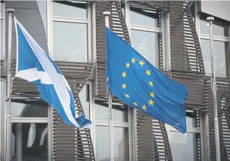  ?? PICTURE: PA ?? The Saltire and EU flags fly outside the Scottish Parliament in Edinburgh