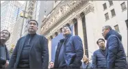  ?? Associated Press ?? Visitors from China take in the view outside the New York Stock Exchange on Tuesday.