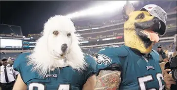  ?? Patrick Semansky Associated Press ?? BEAU ALLEN, left, and Chris Long embrace the Eagles’ underdog mentality after beating Minnesota on Sunday in the NFC championsh­ip game. They’re the biggest Super Bowl underdog since Arizona in 2009.