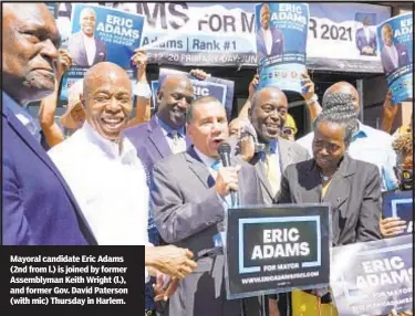  ??  ?? Mayoral candidate Eric Adams (2nd from l.) is joined by former Assemblyma­n Keith Wright (l.), and former Gov. David Paterson (with mic) Thursday in Harlem.