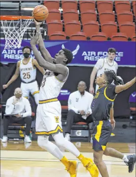  ?? Isaac Brekken The Associated Press ?? Wyoming forward Graham Ike soars to the basket past San Jose State guard Jalen Dalcourt in the second half of the Cowboys’ 111-80 win Wednesday.