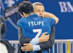  ?? | AP ?? Frank Klopas (with the Impact’s Felipe Martins) was 34-25-17 as the Fire’s coach.