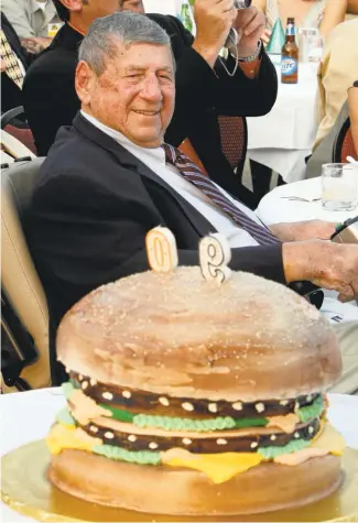  ?? GENE J. PUSKAR/ASSOCIATED PRESS ARCHIVES ?? Big Mac creator Michael “Jim” Delligatti sits behind a Big Mac birthday cake at his 90th birthday party in Canonsburg, Pennsylvan­ia. Delligatti died Monday at home in Pittsburgh. He was 98.