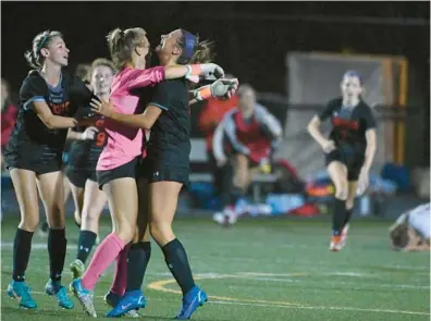  ?? BRIAN KRISTA/BALTIMORE SUN MEDIA ?? Glenelg’s Carln Costell, from left, Bella Buscher and Kendall Anderson celebrate their 3-2 win over Hereford in a Class 2A state semifinal game Friday night at Gaithersbu­rg High.