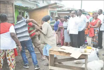  ??  ?? Town Clerk Royston King (centre on phone) and other City Hall members watched on as the stalls were being reposition­ed yesterday.