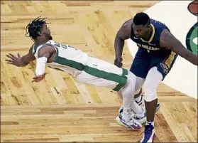  ?? Ap ?? New Orleans Pelicans forward Zion Williamson, right, collides with Boston celtics guard Marcus smart during Monday night’s game.