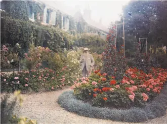  ?? Troob Family Foundation ?? An anonymous 1921 color photograph shows Monet in his garden at Giverny, where he spent his time in later life painting his surroundin­gs.