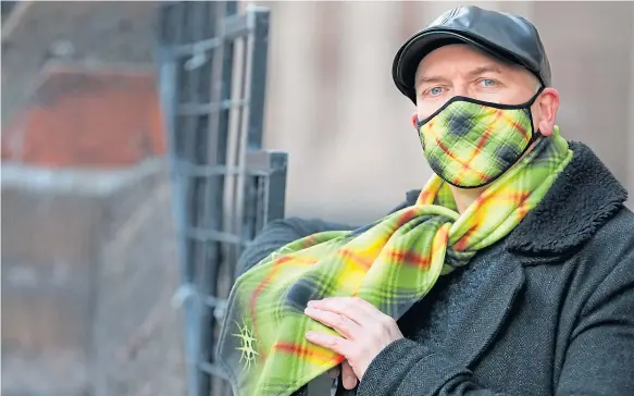  ??  ?? Steven models a scarf and mask made in his new warning tartan.