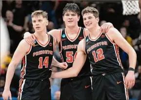  ?? José Luis Villegas / Associated Press ?? Princeton guard Matt Allocco (14) forward Zach Martini (54) and forward Caden Pierce (12) and teammates embrace in the final seconds first-round upset against Arizona in the NCAA Tournament. Allocco said missing out on the 2020-21 season, which was canceled by the Ivy League, brought the team closer together.