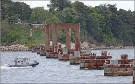  ?? MATT STONE / HERALD STAFF ?? NOWHERE FAST: Pylons are all that is left from the Long Island Bridge, which was demolished in 2015 because of safety issues.