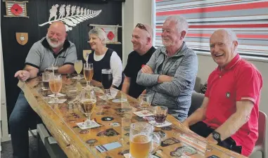  ?? NEIL HODGSON ?? Kevin Sweeney, left, (navy), Judy Sweeney, Kyle Abbott (air force) and Steve Cox (air force) and Barry O’Neil, share a drink, some stories and a laugh around the memorial table at the Motueka RSA.