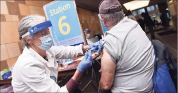  ?? Arnold Gold / Hearst Connecticu­t Media ?? Matthew Naclerio, 73, of North Haven gets his first dose of a COVID-19 vaccine from Dr. Soni Clubb at the Floyd Little Athletic Center in New Haven on Feb. 14.