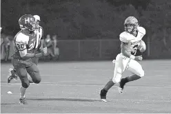  ?? Staff photo by Evan Lewis ?? right Hughes Springs quarterbac­k Alex Bruce tries to outrun Hooks linebacker Malik Estell during the Sept. 16, 2016, game in Hooks. The Hornets beat Hughes Springs.