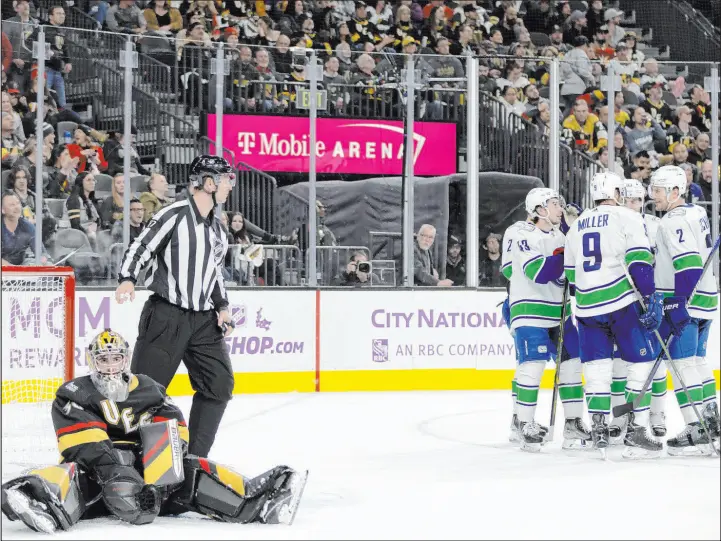  ?? Ellen Schmidt
Las Vegas Review-journal @ellenschmi­dttt ?? The Canucks celebrate their fifth goal Saturday night as goaltender Logan Thompson contemplat­es what would be the Knights’ fourth loss in their past six home games.