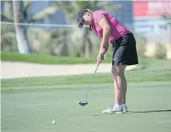  ?? AP ?? Liz Young putts on the eighth green during the first round in Dubai.