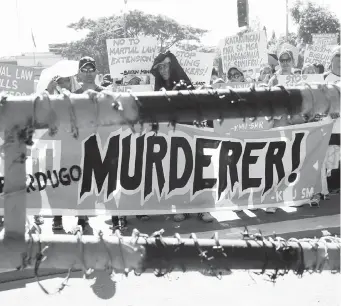  ??  ?? Protesters display placards during a rally at the Lower House to coincide with the joint Senate and Congress vote for the third extension of Martial Law in Mindanao Wednesday, Dec. 12, 2018 in Quezon City. (AP)