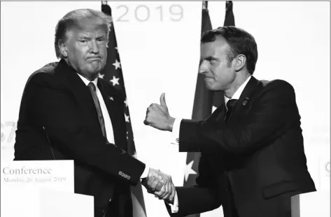  ??  ?? French President Emmanuel Macron and U.S President Donald Trump shake hands during conference during the G7 summit on Monday in Biarritz, southweste­rn France. AP PhoTo/FrAncoIs MorI