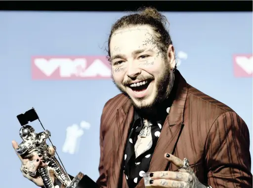  ?? Picture: Evan Agostini/Invision/AP ?? US rapper Post Malone poses with the award for song of the year for ‘Rockstar’ in the press room at the MTV Video Music Awards at Radio City Music Hall earlier this month in New York.