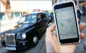  ?? PHOTO: REUTERS ?? A photo illustrati­on shows the Uber app and a black cab in London.