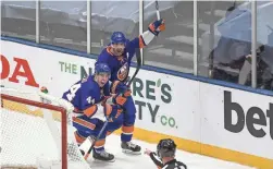  ?? DENNIS SCHNEIDLER/USA TODAY SPORTS ?? Islanders center Jean-Gabriel Pageau (44) celebrates his game-winning goal with right wing Cal Clutterbuc­k (15) during their game against the Bruins on Monday.
