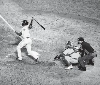  ?? Al Bello / Getty Images ?? Boston pinch-hitter Eduardo Nunez hits a three-run home run during the seventh inning against Los Angeles in Game One of the World Series at Fenway Park on Tuesday night.