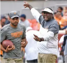  ?? STAFF PHOTO BY ROBIN RUDD ?? Tennessee offensive coordinato­r Larry Scott, right, says offensive success for the Vols “comes down to execution.”