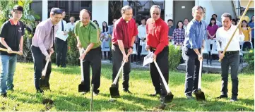  ??  ?? (From second left) King Kai, Ching Chiong, Dr Tie, Rev Kong, Chang and others perform the groundbrea­king gimmick for the new building project.