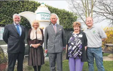  ??  ?? The Prince of Wales looks at the teapots; and right, Keith Blazye, the Duchess of Cornwall, Prince Charles, Susan and Luke Blazye