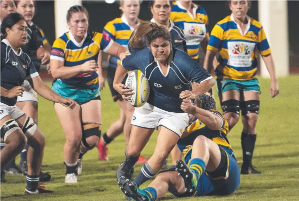  ?? ?? FNQ Lightning’s Asta Naden runs through the Townsville Brolgas defence at Barlow Park on Saturday. Picture Emily Barker