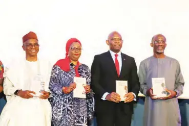  ?? PHOTOS: ?? From left, Governor, El-Rufai, Hadiza El-Rufai and Tony Elumelu, UBA Chairman, pose with the novel, ‘An Abundance of Scorpions’. Abdul Musa