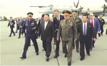  ?? ?? North Korea’s leader Kim Jong Un (centre) and Russia’s Defence Minister Sergei Shoigu (right) inspect Russian military aircraft and missiles put on display at Knevichi aerodrome near Vladivosto­k in the Primorsky region