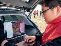  ?? ?? An agricultur­al technician downloads and analyses data collected by a drone with BDS on a farm in Laixi, Shandong Province, on 28 February