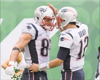  ?? Bill Kostroun / Associated Press ?? Patriots tight end Rob Gronkowski, left, celebrates with Tom Brady after the two connected for a touchdown during the second half of Sunday’s 24-17 victory over the Jets.