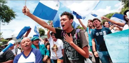  ?? DIANA ULLOA/AFP ?? Anti-government demonstrat­ors shout slogans in Nicaraguan capital Managua on Wednesday, while President Daniel Ortega attended so-called ‘national dialogue’ talks with Roman Catholic bishops and the opposition.