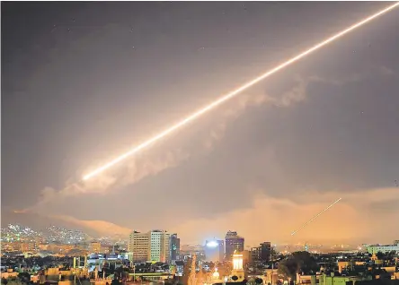  ?? HASSAN AMMAR/AP ?? The sky over Damascus erupts with surface-to-air missile fire as the U.S. launches an attack on Syria early Saturday.