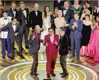  ?? Myung J. Chun Los Angeles Times ?? THE TEAM behind “Everything Everywhere All at Once” celebrates its best picture win. Directors Daniel Scheinert, from left, and Daniel Kwan accept the award alongside producer Jonathan Wang.