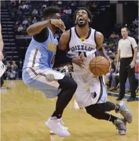  ??  ?? MEMPHIS: Memphis Grizzlies guard Mike Conley (11) drives against Denver Nuggets guard Emmanuel Mudiay (0) in the second half of an NBA basketball game Tuesday, in Memphis, Tenn. — AP