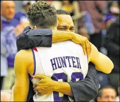  ?? CURTIS COMPTON / CCOMPTON@AJC.COM ?? Georgia State coach Ron Hunter, embracing son R.J. in 2015, can become the school’s all-time winningest coach with a victory today.