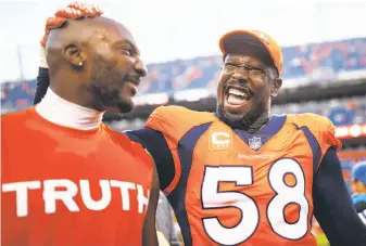  ?? Justin Edmonds / Getty Images ?? Denver linebacker Von Miller (58) and cornerback Aqib Talib celebrate as they leave the field after the Broncos’ 42-17 romp over Dallas on Sept. 17. The Broncos host the Raiders on Sunday.