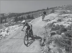  ?? Contribute­d ?? Two cyclists ride the trails at Big White Ski Resort’s newly opened bike park. Full-day biking lift tickets are available to purchase for just $25 from the on-mountain ticket office; kids aged 12 and under can ride for $15.